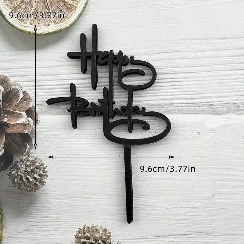 Black acrylic birthday cake topper set with text and a stick on a white wooden background