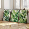 A set of three framed tropical watercolor leaf art prints featuring lush green foliage on a light background.