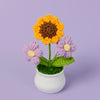 Handmade knitted orange and yellow sunflower flower in a white pot