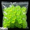 A bag of glow-in-the-dark resin charms shaped like cats and ducks in various shades of lime green.