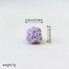 A set of three small, round, purple ocean animal cake toppers: a whale, an octopus, and a turtle.