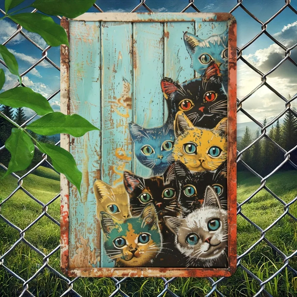 A vintage metal tin sign featuring a collage of humorous cats in various poses, displayed on a wire fence.
