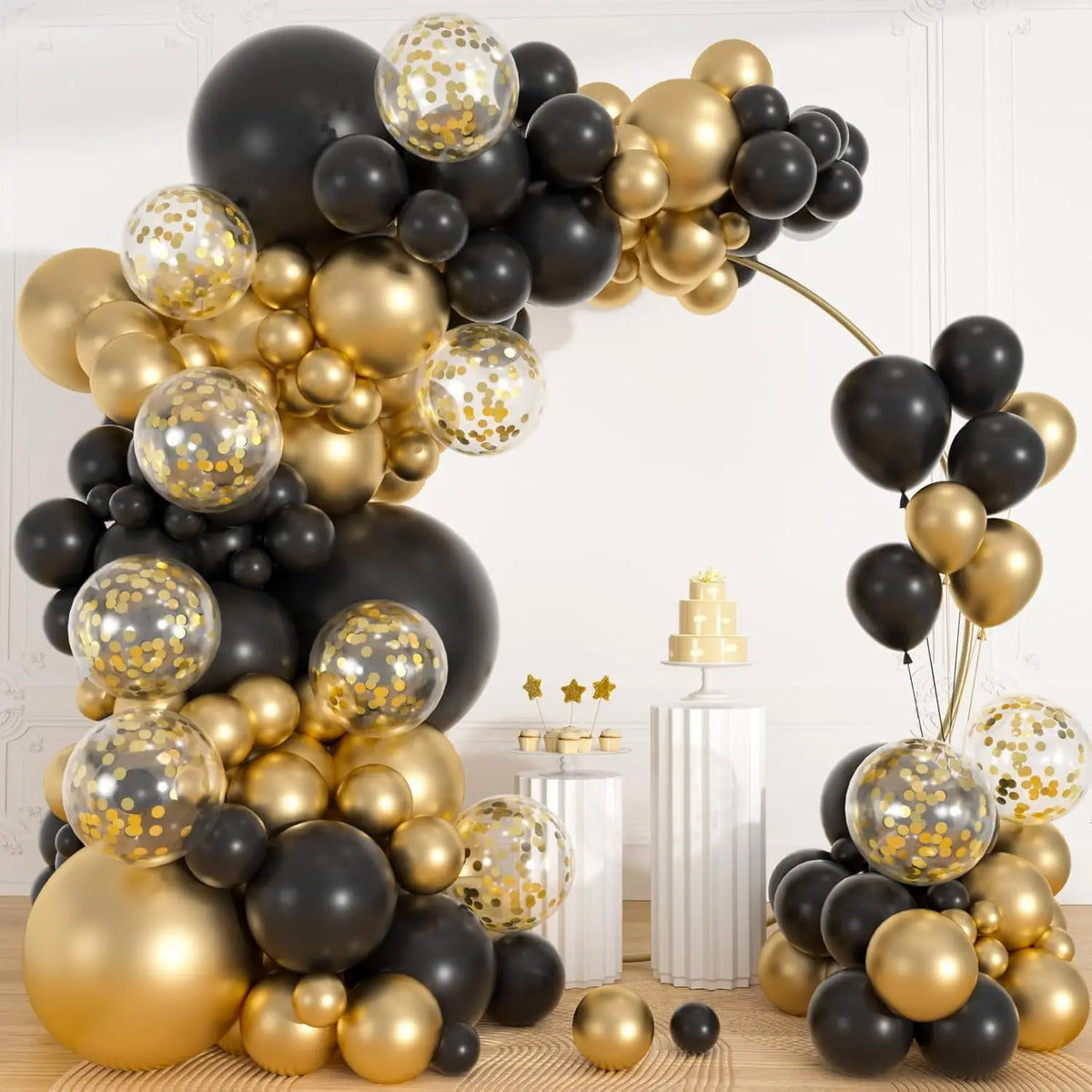 A balloon garland arch featuring black and gold balloons with gold confetti, displayed against a white background.