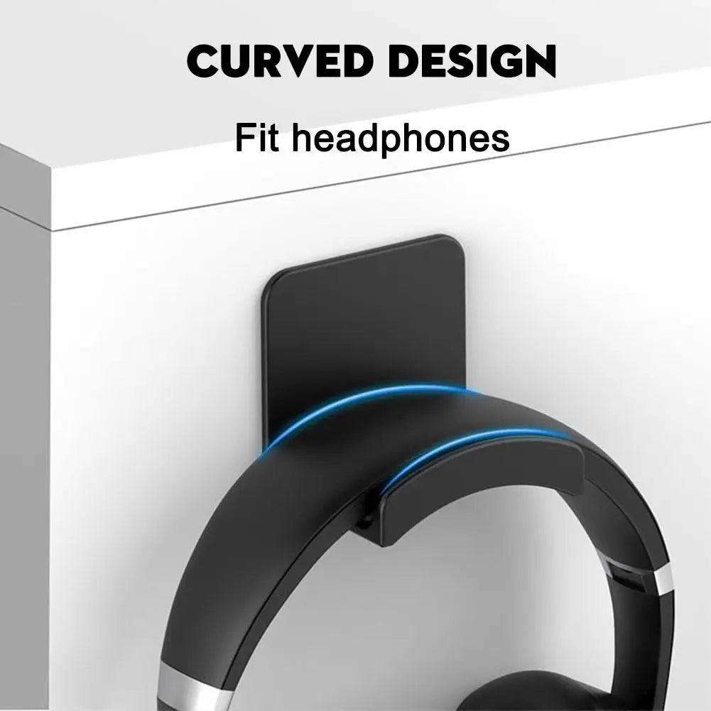 A black curved wall-mounted headphone holder designed to fit headphones.