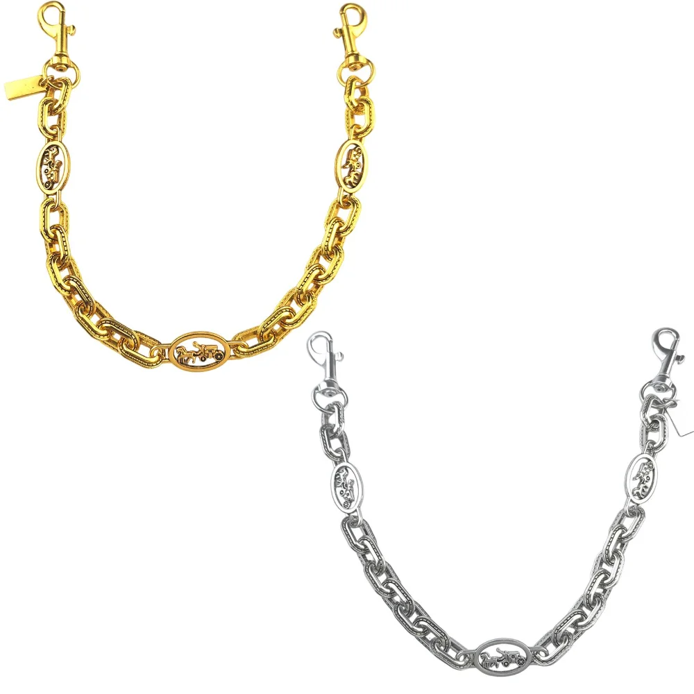 A close-up view of a gold paperclip chain bag strap and a silver chain bag strap.