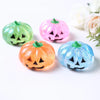 Four glittery stress balls shaped like pumpkins in green, pink, orange, and blue.