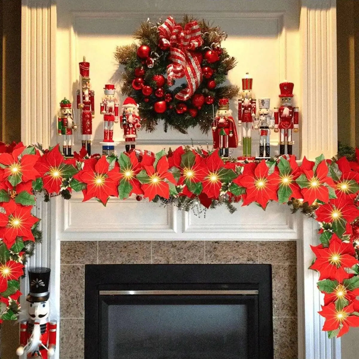A festive display featuring a wreath of red poinsettia flowers and various Christmas ornaments on a mantelpiece.