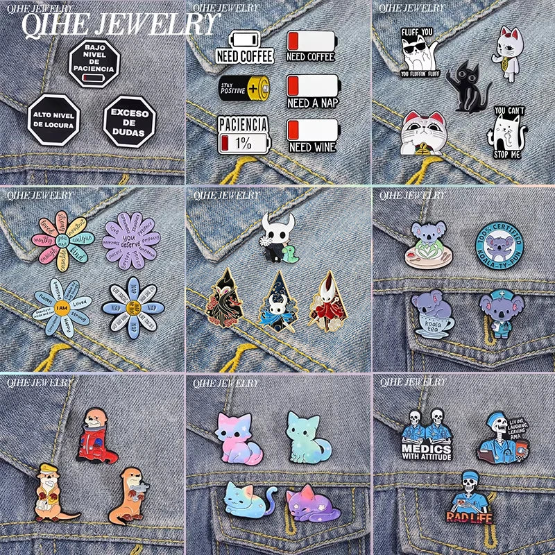 A collection of enamel pins featuring cartoon cats, flowers, and various designs on denim fabric.