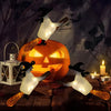 A carved pumpkin jack-o'-lantern is surrounded by twelve glowing white LED candles shaped like bats and a magic wand.