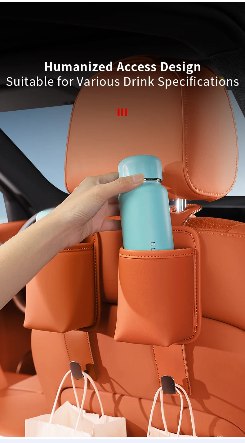 A hand places a light blue water bottle into a storage slot on an orange car seat back organizer.