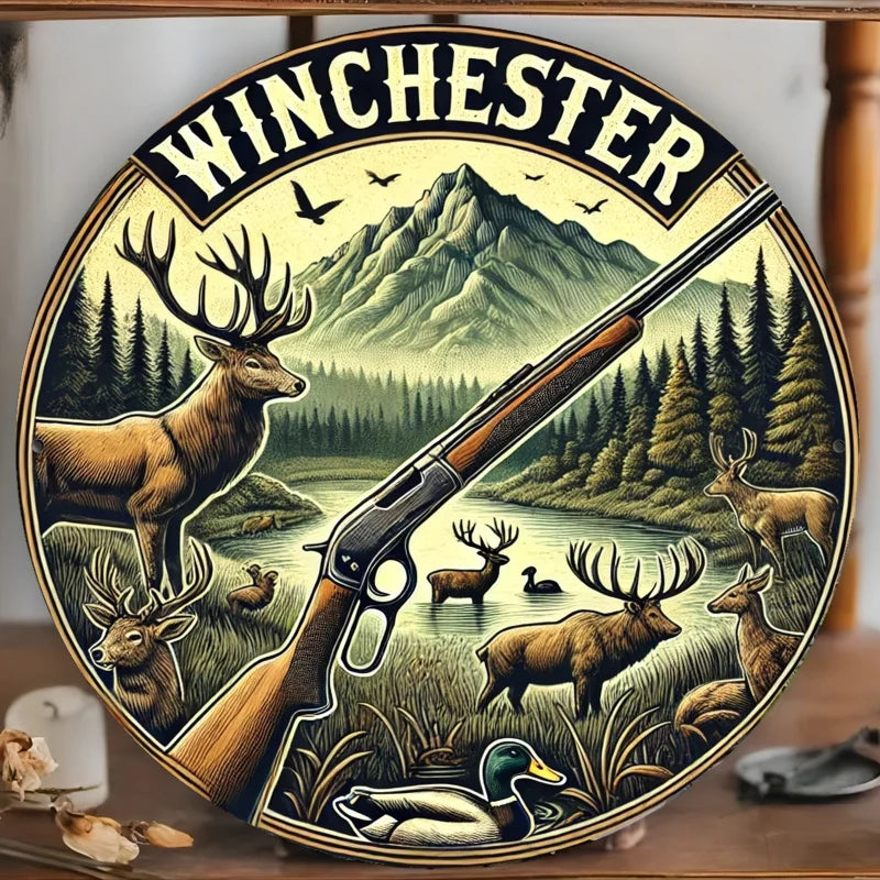 Vintage hunting scene metal wall sign featuring a deer and rifle silhouette against a mountain landscape.