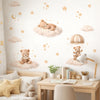 A wall decorated with cartoon bear, star, and cloud stickers for a kids room