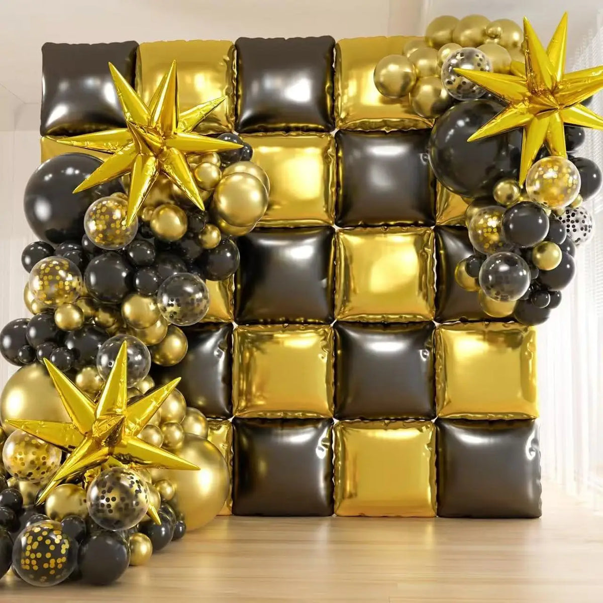 A wall display of black and gold foil balloons shaped into squares and stars for celebrations