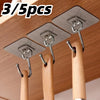 Three silver adhesive wall hooks are shown mounted on a wooden surface for home organization.