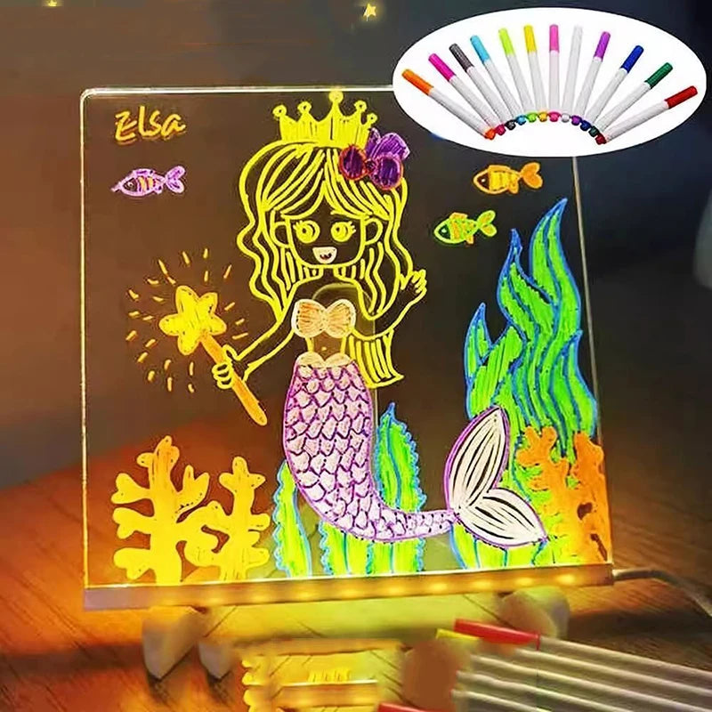 لوحة رسم أكريليك مضيئة لعروس البحر وتتويج، مع مجموعة من أقلام التلوين الملونة فوقها.