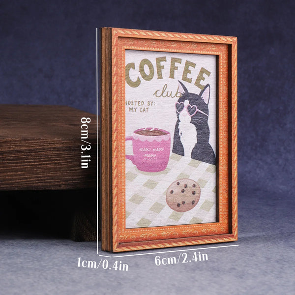 A framed vintage smoking cat fridge magnet featuring a black and white cat illustration on a light background.