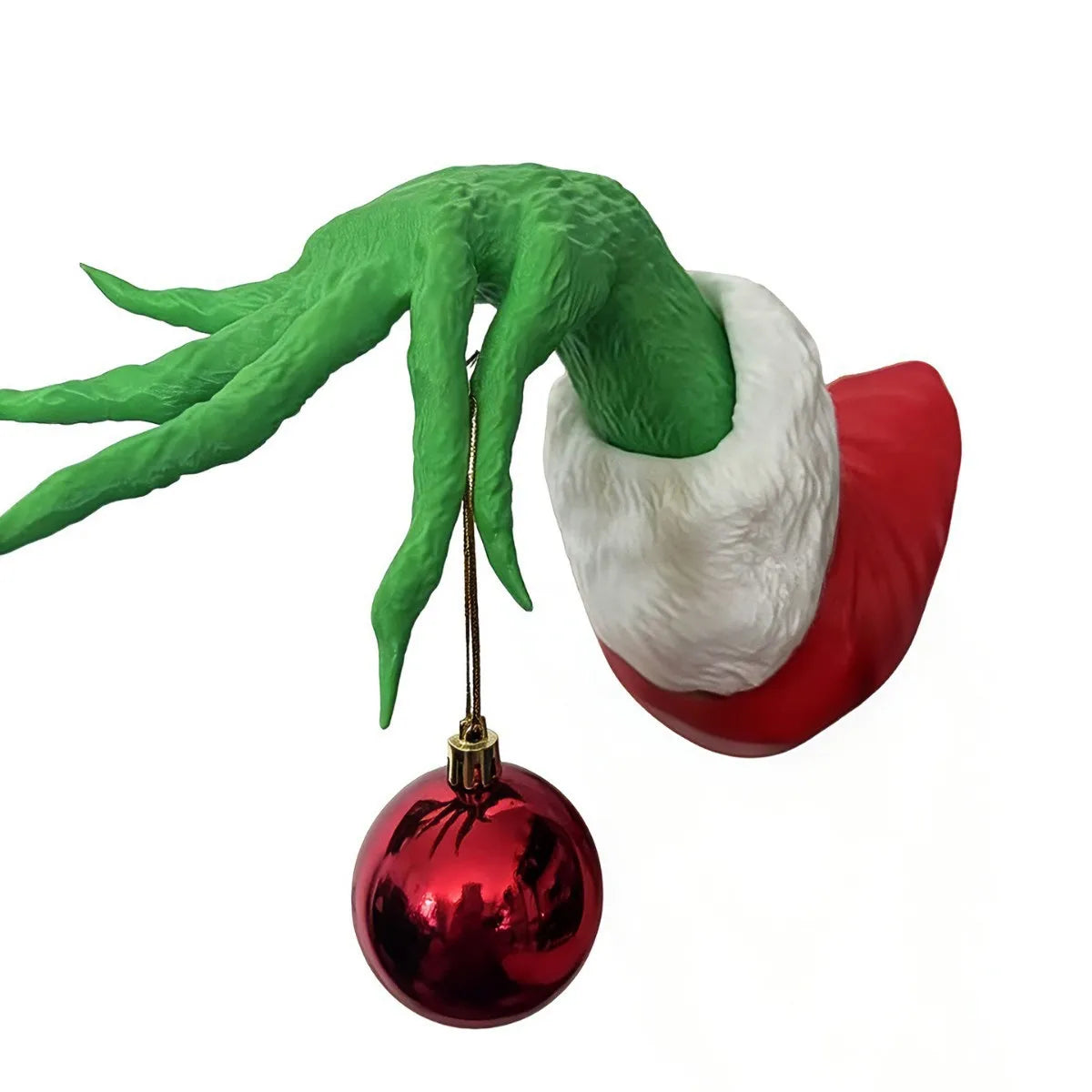 Green monster hand with long fingers holding a red Christmas ornament