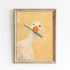 A painting of a white duck against a yellow background in a gold frame.