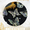 A collection of gold-colored butterfly stickers on a black background, displayed within a circular frame.