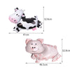 A white and black cow-shaped decoration for a birthday party, shown in profile view.