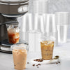 Clear plastic cups with sip lids and ice drinks displayed on a light surface.
