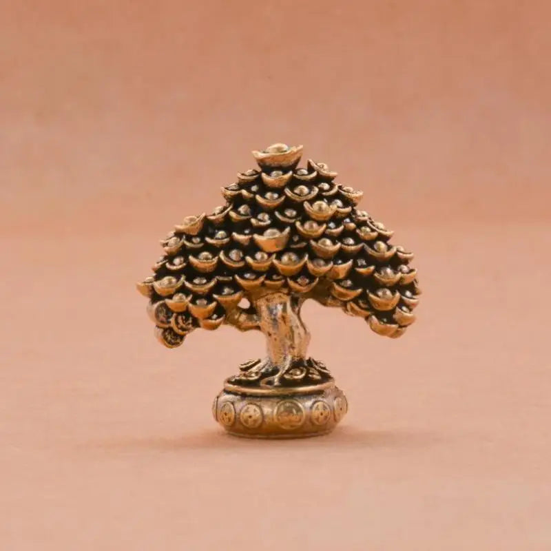 A brass fortune tree ornament featuring a detailed pinecone shape with ingot accents.