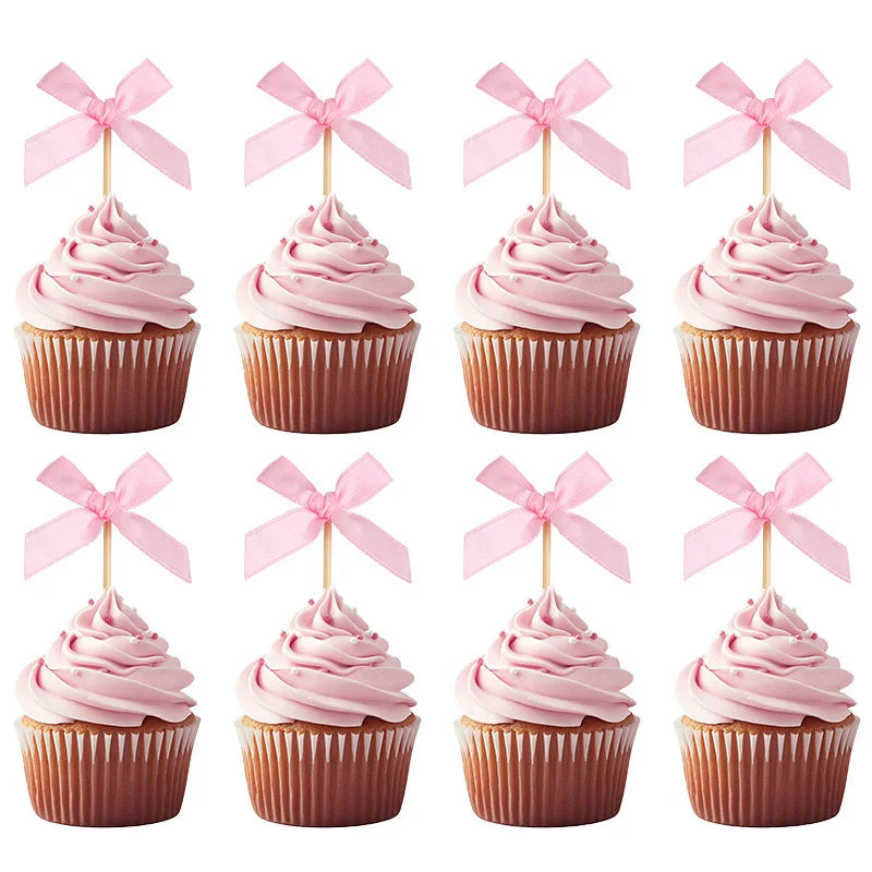 Four pink cupcake toppers featuring decorative bows for parties and celebrations.
