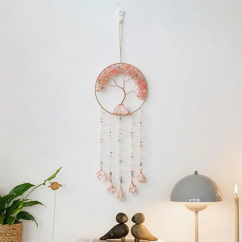A crystal tree of life sun catcher wall decor with a circular frame and hanging crystal elements.