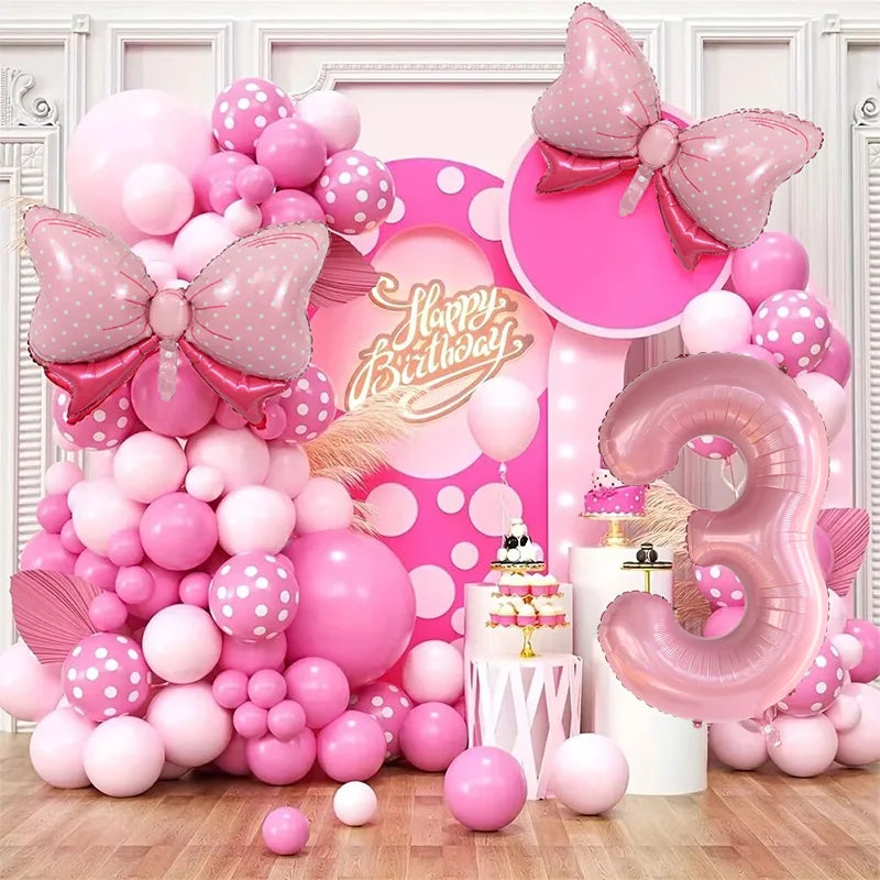 A pink and white balloon garland arch kit featuring numerous balloons in various shades of pink and white.