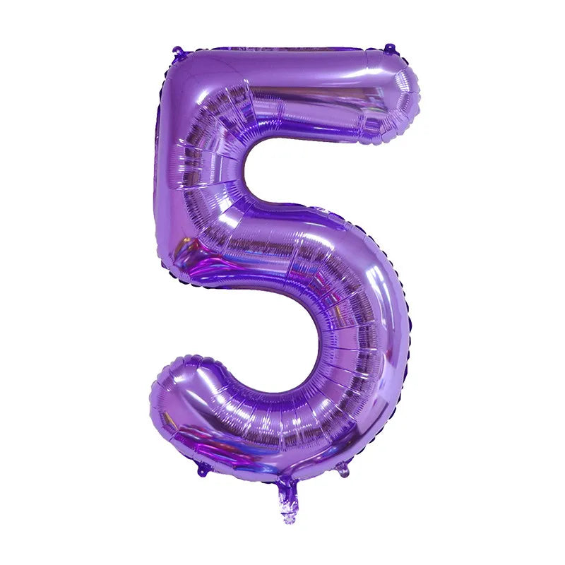 A purple foil balloon shaped like the number five.