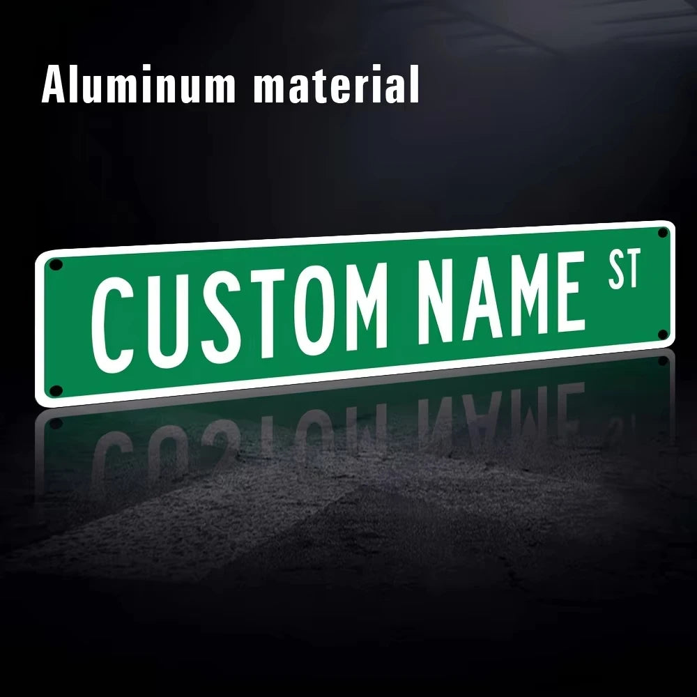 A green aluminum street sign with custom name text on a dark background.