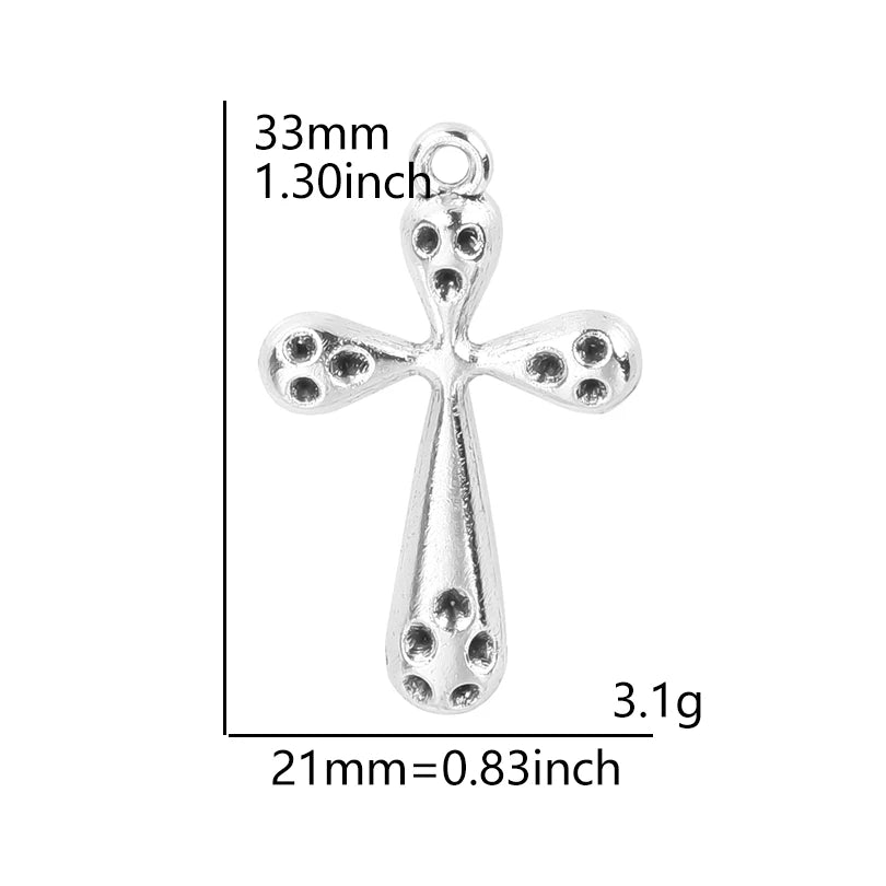A silver cross charm measuring 33mm long and weighing 3.1 grams.