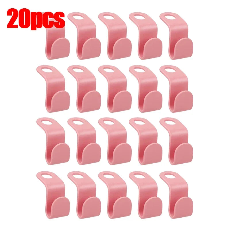 A set of 20 pink space-saving hanger connector hooks for organizing items.