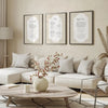 A display of Islamic wall art prints featuring Ayatul Kursi, 4 Quls, and Surah Al-Fatiha on framed canvases.