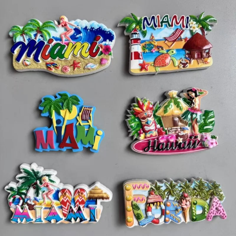A collection of colorful fridge magnets featuring Miami and Hawaii themes, including palm trees, tropical fruits, and city la