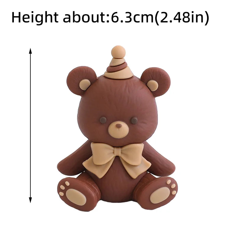 A brown cartoon elephant cake topper with a bow tie and a conical horn.