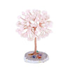 A crystal money tree decor featuring pink blossoms and a base of natural stones.