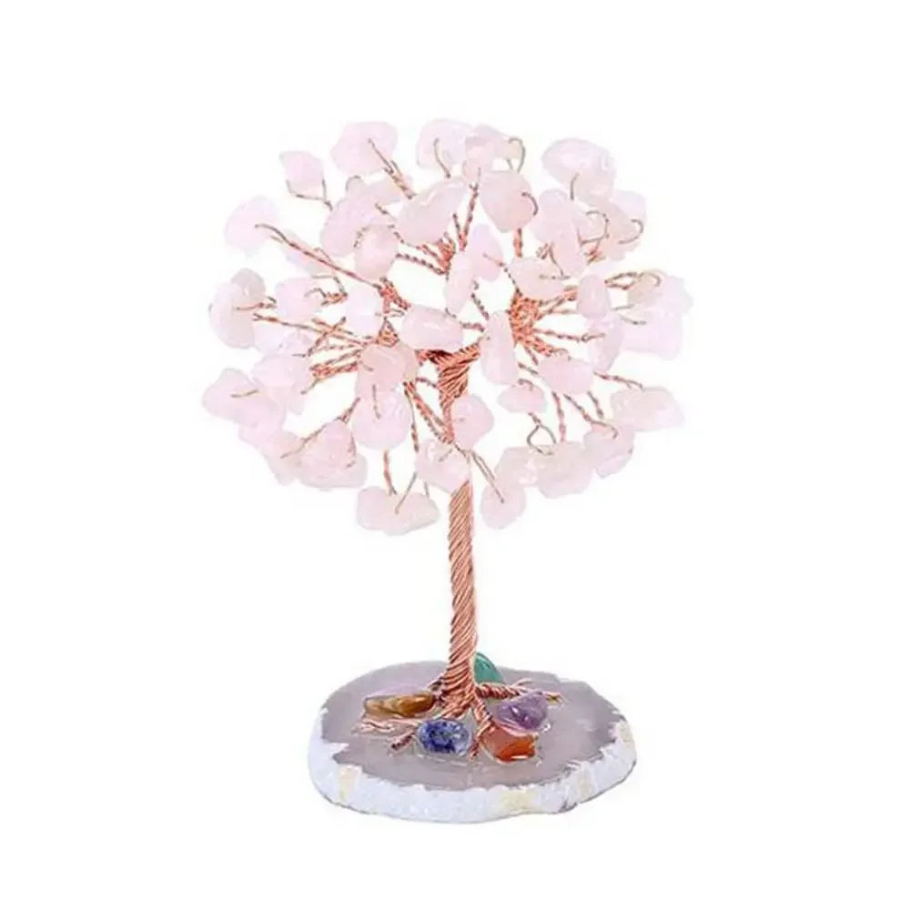 A crystal money tree decor featuring pink blossoms and a base of natural stones.
