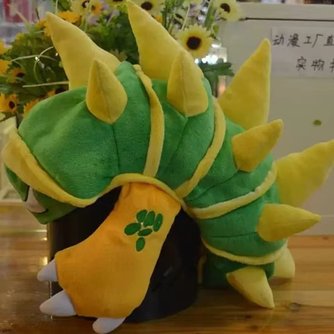 A plush knit cap of Tony Tony Chopper featuring green and yellow colors with spiky protrusions.