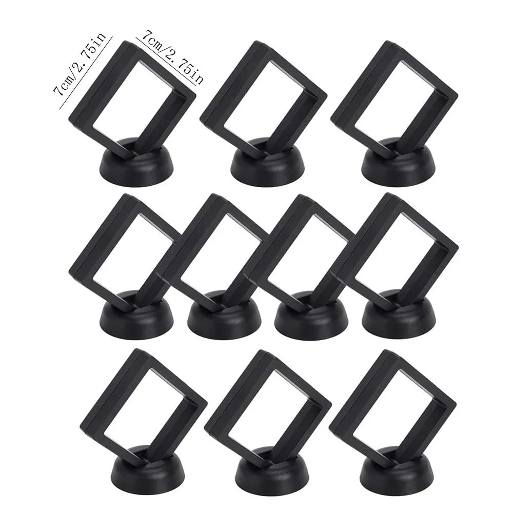 A set of ten black floating shadow box jewelry display frames with 7cm wide openings.