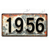 A vintage aluminum license plate tag with the year 1956, showing signs of wear and rust.