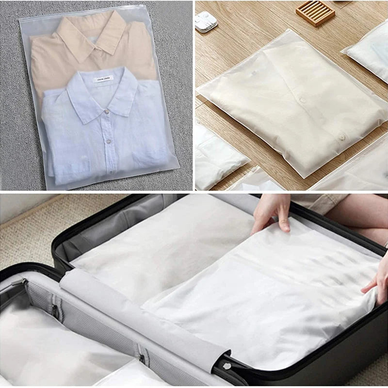 A set of clear zippered storage bags containing folded light-colored shirts and clothing items.