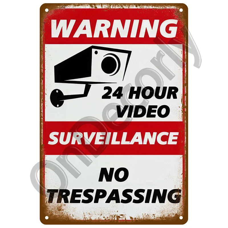 Vintage metal warning sign with text indicating 24 hour video surveillance and no trespassing