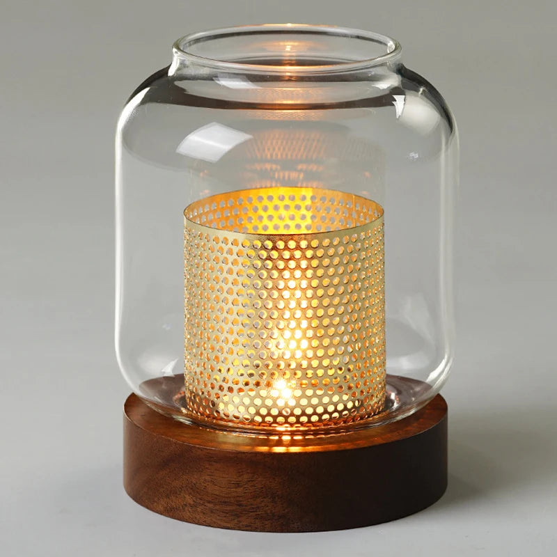 Vintage wooden candle lantern with a glass cover emitting a warm, glowing light.