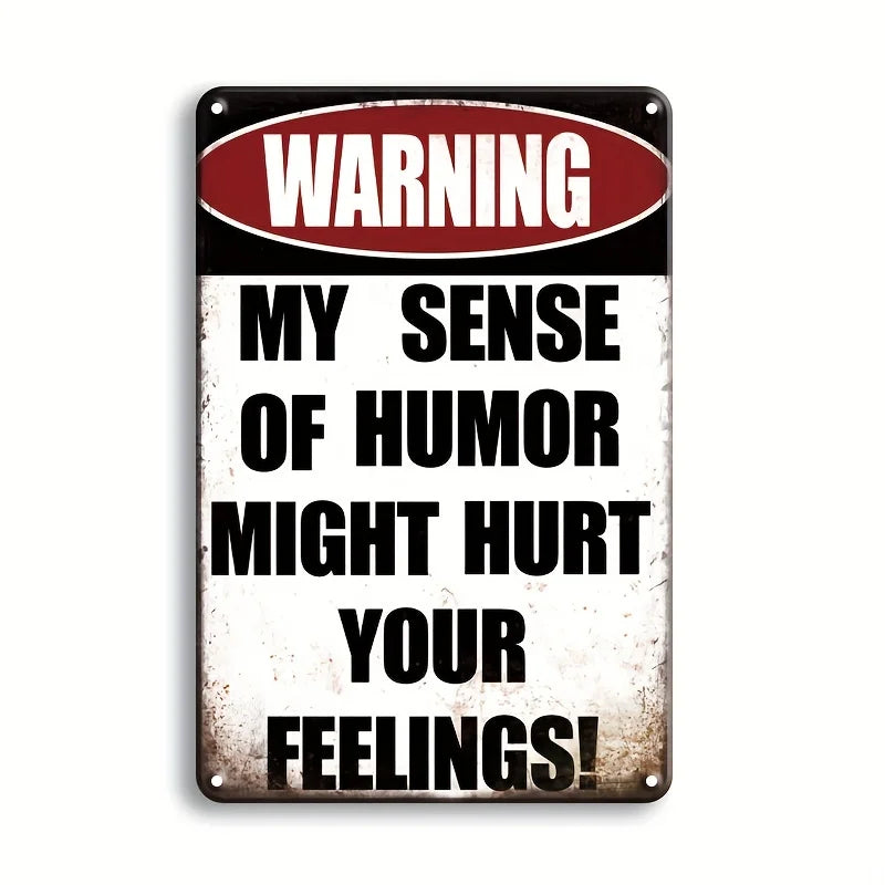 A vintage metal tin sign with a warning that says My sense of humor might hurt your feelings