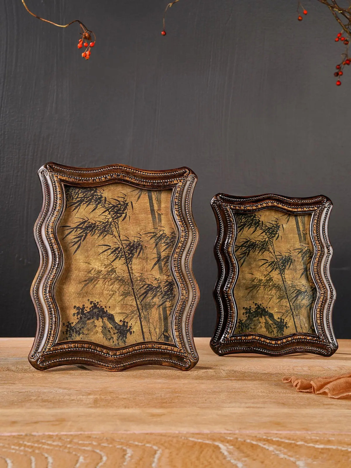 A vintage resin photo frame decor with an ornate, distressed gold-toned frame and a dark botanical print.