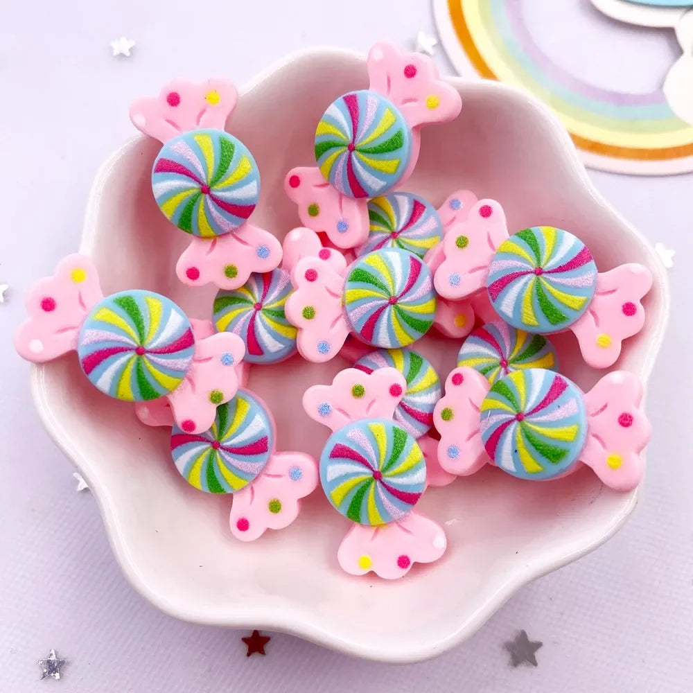 Pink and multicolored candy resin cabochons shaped like flowers and balls for crafting