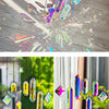 A set of seven crystal prism sun catchers hanging, catching sunlight and creating colorful light patterns.