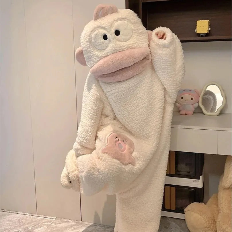 A white fleece onesie pajama for a baby or toddler with pink accents, displayed on a shelf.