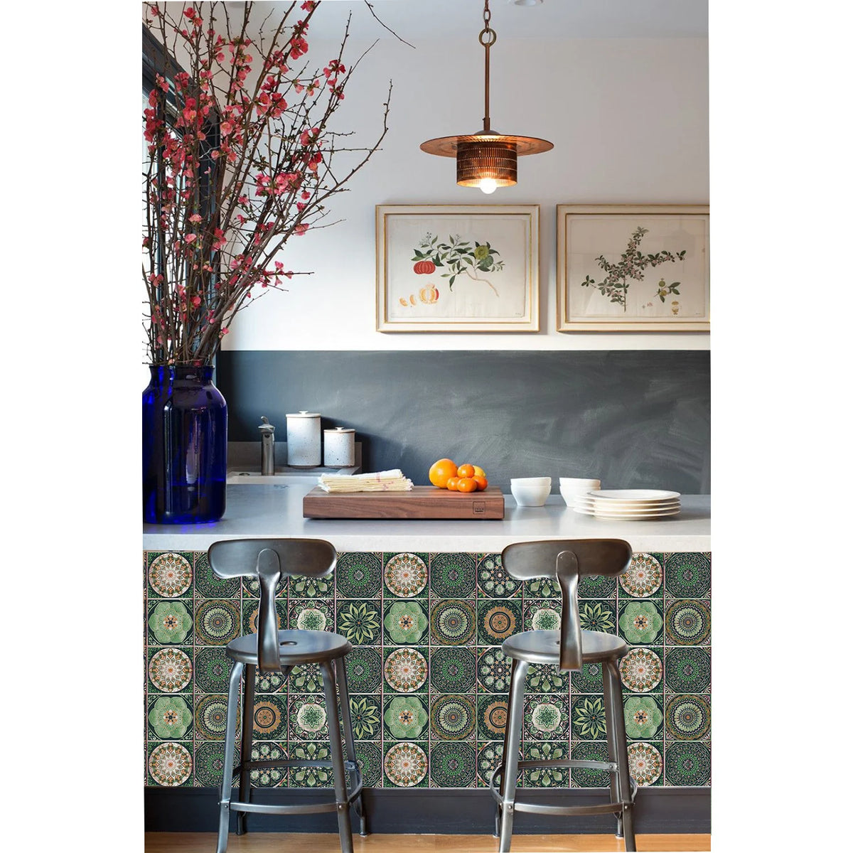 A kitchen backsplash featuring a patterned tile design and wooden bar stools beneath framed artwork.